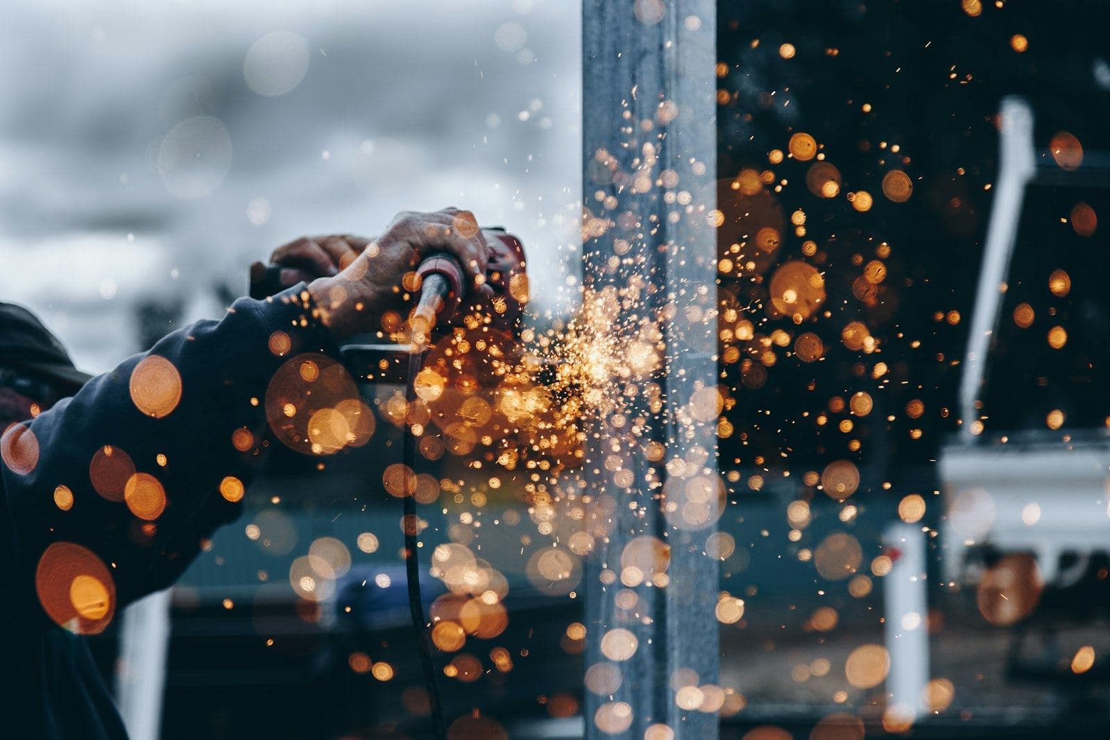 Sparks flying from a grinder in a metal workshop